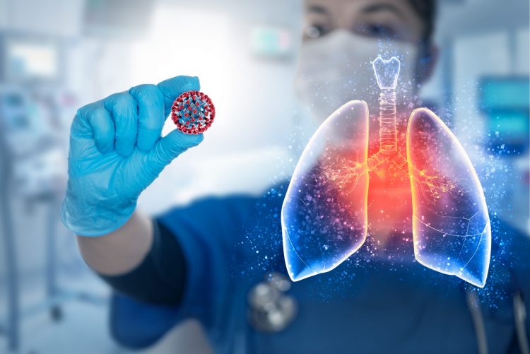 doctor holding a SARS-CoV-2 particle next to a picture of lungs