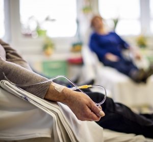 patient recieving chemotherapy through IV in a hospital ward