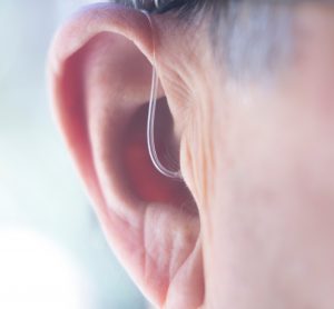 close up of a man's ear with a hearing aid in - idea of deafness