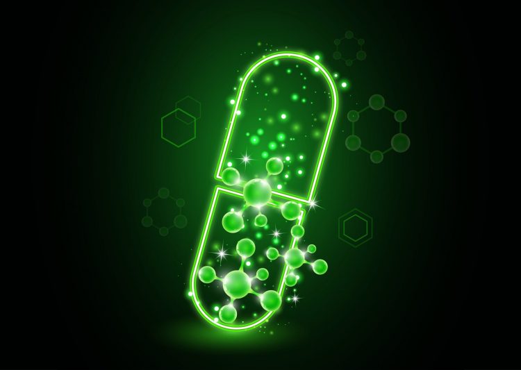 Glowing green pill with molecules coming out of it