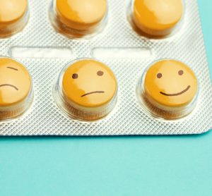 Yellow antidepressant pills with smiley faces drawn on