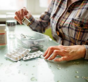 Woman with rheumatoid arthritis chhecking medicines